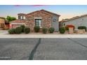 Charming single-Gathering home featuring stone accents, desert landscaping, and a well-maintained front yard at 19550 N Grayhawk Dr # 1117, Scottsdale, AZ 85255