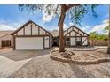 Inviting home with a two-car garage, desert landscaping, and a well-kept lawn at 20626 N 5Th Ave, Phoenix, AZ 85027