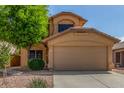 Charming two-story home featuring a stucco facade, well-maintained landscaping, and a two-car garage at 21621 N 48Th Pl, Phoenix, AZ 85054