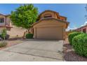 Charming two-story home featuring a stucco facade, well-maintained landscaping, and a two-car garage at 21621 N 48Th Pl, Phoenix, AZ 85054