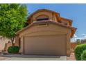 Charming two-story home featuring a stucco facade, well-maintained landscaping, and a two-car garage at 21621 N 48Th Pl, Phoenix, AZ 85054