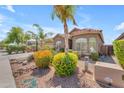 Exterior of a single-story home with a tile roof, desert landscaping, and a charming front facade at 22346 N 104Th Ln, Peoria, AZ 85383