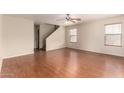 Living room with hardwood floors, a ceiling fan, and a view to the stairs at 2893 E Cherry Hills Dr, Chandler, AZ 85249