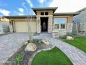 Inviting single-story home with desert landscaping, rock accents, and a charming paver walkway at 32978 N 131St Dr, Peoria, AZ 85383