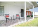 Cozy front porch featuring two chairs, a table, and a decorative outdoor rug at 4010 E Catalina Dr, Phoenix, AZ 85018