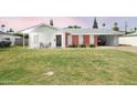 Inviting single-story home with a well-manicured front lawn and convenient carport at 4010 E Catalina Dr, Phoenix, AZ 85018