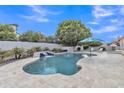 Resort-style pool with waterfall feature, lounge chairs, and lush landscaping at 4061 E Hope St, Mesa, AZ 85205