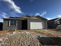Newly constructed single-story home with a garage and unfinished landscaping with a partly cloudy blue sky overhead at 4345 E Brook Lynn Pl, San Tan Valley, AZ 85143