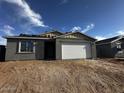 New construction single-Gathering home featuring a gray stucco exterior and two-car garage at 4345 E Brook Lynn Pl, San Tan Valley, AZ 85143