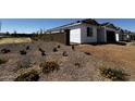 Home under construction, showcasing block wall and native landscaping with flowering plants at 4345 E Brook Lynn Pl, San Tan Valley, AZ 85143
