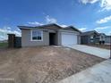 Single-story home featuring a gray stucco exterior, a two-car garage, and a concrete driveway at 4345 E Brook Lynn Pl, San Tan Valley, AZ 85143