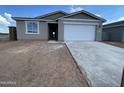 A charming single-story home featuring a gray stucco exterior, a two-car garage, and a concrete driveway at 4345 E Brook Lynn Pl, San Tan Valley, AZ 85143