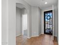 Bright foyer with neutral walls, tile flooring, and an arched doorway at 43507 W Cydnee Dr, Maricopa, AZ 85138