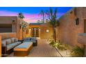 Inviting courtyard with comfortable seating, a paver walkway, and desert landscaping at 4450 E Camelback Rd # 4, Phoenix, AZ 85018