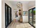 Bright foyer featuring wood-look tile flooring, modern lighting, and stylish decor at 4450 E Camelback Rd # 4, Phoenix, AZ 85018