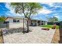 Spacious backyard featuring a brick patio, mature trees, and covered seating area at 508 S Ernie Pl, Tempe, AZ 85281