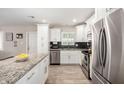 Bright kitchen with white cabinets, stainless steel appliances, and granite countertops at 508 S Ernie Pl, Tempe, AZ 85281