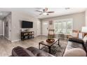 Inviting living room with wood-look tile flooring, plantation shutters, and comfortable seating at 508 S Ernie Pl, Tempe, AZ 85281