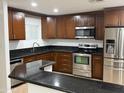 This kitchen features dark cabinets, stainless steel appliances, and granite countertops at 5338 W Wolf St, Phoenix, AZ 85031