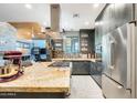 Gourmet kitchen featuring stainless steel appliances, a center island, granite countertops and dark cabinetry at 534 W 15Th St, Tempe, AZ 85281