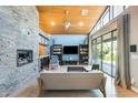 Bright living room with a stone accent wall fireplace, modern furnishings and vaulted wood ceilings at 534 W 15Th St, Tempe, AZ 85281