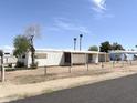 Exterior view of mobile home, including palm trees at 6950 W Karen Lee Ln, Peoria, AZ 85382