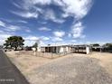 Wide angle shot of the mobile home with a chain-link fence surrounding the perimeter at 6950 W Karen Lee Ln, Peoria, AZ 85382