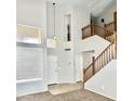 Spacious entryway features high ceilings, an adjacent staircase, and a large window bringing in natural light at 7117 W Globe Ave, Phoenix, AZ 85043