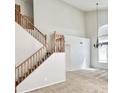 Bright entryway showcases a staircase with wooden banisters and natural lighting from a large arched window at 7117 W Globe Ave, Phoenix, AZ 85043