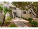Inviting exterior with stairs leading to upper levels and lush landscaping at 7700 E Gainey Ranch Rd # 102, Scottsdale, AZ 85258