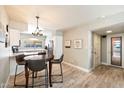 Open floor plan with kitchen and dining area, featuring wood-look tile and modern lighting at 7736 E Hazelwood St, Scottsdale, AZ 85251