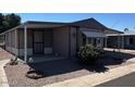 Charming single-story home with a covered porch and easy-to-maintain gravel landscaping at 8103 E Southern Ave # 157, Mesa, AZ 85209