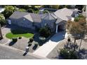 Beautiful stone home with lush landscaping, a porte-cochere and a charming circular design feature at 8441 W Foothill Dr, Peoria, AZ 85383