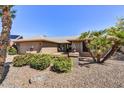 Beautiful single-story home featuring desert landscaping, a quaint porch, and a two-car garage at 9226 W Topeka Dr, Peoria, AZ 85382
