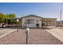 Single-story home with carport and desert landscaping at 931 S 91St Pl, Mesa, AZ 85208