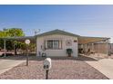 Single-story home with carport and desert landscaping at 931 S 91St Pl, Mesa, AZ 85208