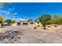 Spacious home featuring a wide driveway, a two-car garage, and a beautifully landscaped front yard at 13238 N 78Th St, Scottsdale, AZ 85260