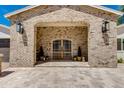 Close-up of the home's arched brick entryway, showcasing its unique architectural details and inviting ambiance at 13238 N 78Th St, Scottsdale, AZ 85260