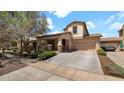 Inviting two-story home with a spacious driveway, a two-car garage, and manicured landscaping at 13256 N 153Rd Ln, Surprise, AZ 85379