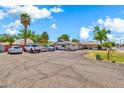Extensive paved parking area leads to a single story home with a charming carport at 1451 E Brown Rd, Mesa, AZ 85203