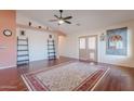 Bright living room featuring hardwood floors, neutral colors, and access to the backyard at 1563 E Racine Dr, Casa Grande, AZ 85122