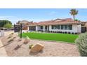 Charming home with well-maintained landscaping, decorative rock, and a manicured lawn at 16008 N 60Th St, Scottsdale, AZ 85254