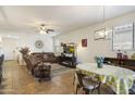 Inviting living room with dining area, comfortable seating, and a cozy fireplace at 1601 S 215Th Dr, Buckeye, AZ 85326