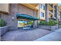 Building entrance with brick facade, awning, and glass doors leading into the lobby at 17 W Vernon Ave # 412, Phoenix, AZ 85003