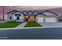 Stunning single-Gathering home with charming curb appeal, green lawn, and a welcoming red door at 1704 E Melrose St, Mesa, AZ 85203