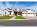 Well-maintained single-Gathering home featuring a manicured lawn, red front door, and a three-car garage at 1704 E Melrose St, Mesa, AZ 85203