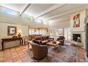 Bright living room with a fireplace, shutters, and tile floors at 1725 E Staghorn Ln, Carefree, AZ 85377