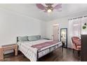 Cozy bedroom featuring hardwood floors, ceiling fan, and natural light through the windows at 1730 W Emelita Ave # 1008, Mesa, AZ 85202