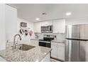 Bright kitchen with stainless steel appliances, granite countertops, and white cabinetry at 1730 W Emelita Ave # 1008, Mesa, AZ 85202