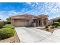 Well-maintained home with a spacious driveway and desert landscaping, creating a welcoming exterior at 18076 W Redwood Ln, Goodyear, AZ 85338